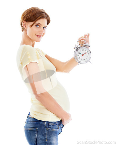 Image of Pregnancy, clock and portrait of woman in studio holding her stomach waiting for birth of her baby. Maternity, prenatal and pregnant girl model with alarm clock for time isolated by white background.