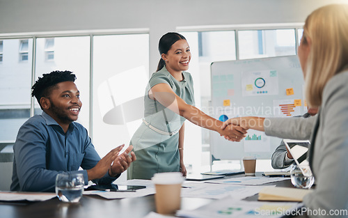 Image of Business people, woman and handshake at meeting, planning and chart on board for target, success or goal. Corporate finance group, applause and celebration for profit, promotion or vision in New York