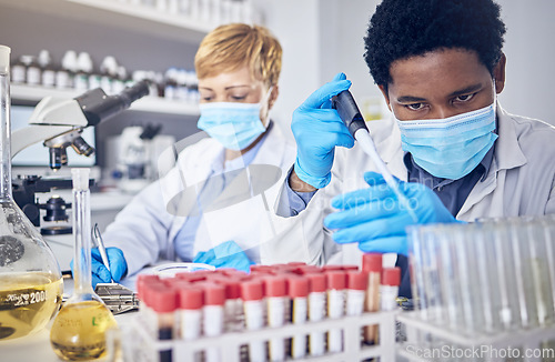 Image of Science, innovation and covid, teamwork in laboratory with test tube and face mask, motivation in future vaccine or cure development. Healthcare, black man and scientist woman doing research in lab.