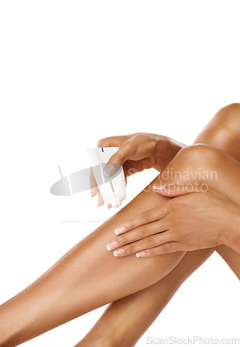 Image of Legs, hands and woman with cream product in studio on a white background. Skincare, makeup cosmetics and female model apply lotion, moisturizer or creme tube for beauty, healthy skin and wellness.