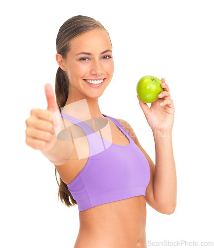 Image of Apple, thumbs up and fitness of woman in studio isolated on white background. Face, portrait and female model with hand gesture and fruit for healthy diet, wellness or nutrition, vitamins or minerals