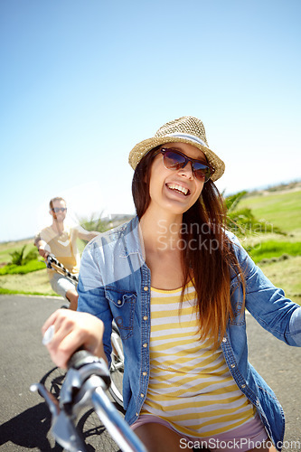 Image of Cycling, travel and woman on couple vacation, summer holiday fun outdoor riding on blue sky background. Bicycle, smile and happy date with partner on bike ride, freedom and happiness with love in sun