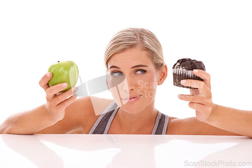 Image of Woman, decision and choice for cupcake, apple and girl isolated on white studio background. Female lady and healthy lifestyle with dessert, fruit and snack for lunch, eating and thinking on backdrop