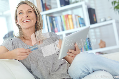 Image of Senior woman on sofa, credit card and tablet for online shopping, ecommerce and digital payments. Mature female, lady and search internet for transactions, daily deals and connection in living room