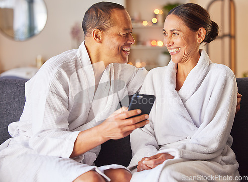 Image of Senior couple, phone and relax spa wellness on sofa, beauty center and luxury body care or streaming video online. Happiness, woman and man smile together for love with smartphone and therapy gown