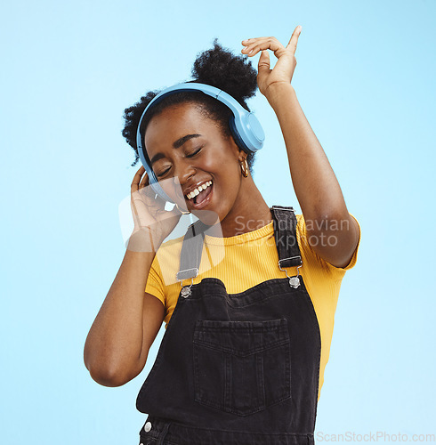 Image of Music, dance and freedom with black woman and headphones, singing for relax, celebration and streaming. Audio, smile and technology with girl listening to online radio for playlist, energy and happy