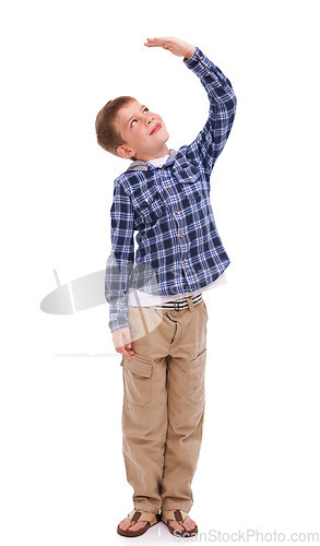 Image of Children, growth and mockup with a boy measuring his height in studio isolated on a white background. Kids, hand and wall with a male child growing up to be tall on blank space for development