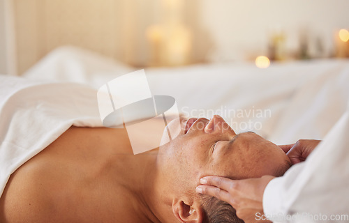 Image of Spa, man and massage for wellness, luxury and relax for health, peace or lying on table. Male person, self care and zen for healthy lifestyle, treatment or grooming for stress relief and head massage