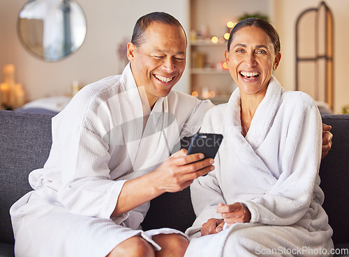 Image of Phone, spa and relax with a couple in a luxury resort for a weekend getaway of bonding together. Portrait, social media and wellness with a man and woman sitting in a health spa or salon for rest