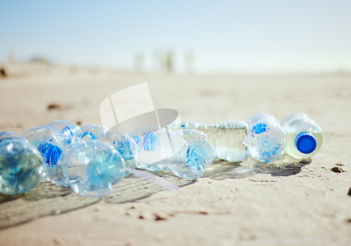 Image of Plastic bottles, beach sand or litter in recycling volunteering, global warming sustainability or earth community service. Zoom, trash texture or ocean waste management in environment nature cleaning