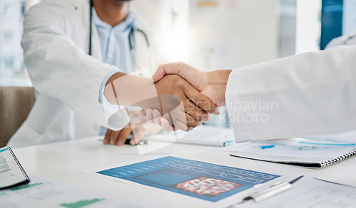 Image of Closeup handshake, doctors and agreement for documents, research or health in hospital to stop virus. Doctor, shaking hands and motivation for healthcare service, wellness or teamwork goal in clinic