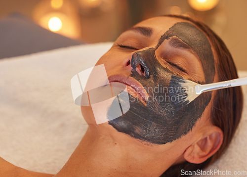 Image of Spa, woman and charcoal face mask, skincare and luxury for health, wellness and clear skin. Beauty, cosmetics and girl with organic facial, detox and natural care for confidence or treatment to relax