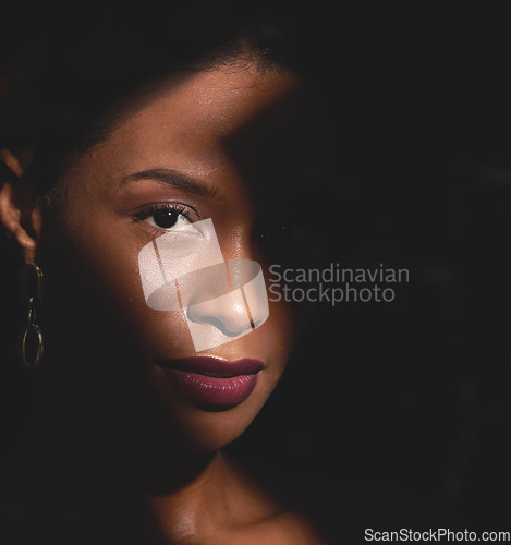 Image of Shadow, black woman and portrait of beauty, makeup and creative spotlight with cosmetics, skincare and glow. Face, model and dark mystery background for facial aesthetic, fantasy and luxury fashion