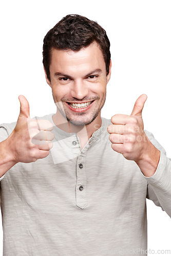 Image of Young man, thumbs up and smile for winning, discount or sale against a white studio background. Portrait of a isolated handsome male giving thumbsup for agreement, yes or approval on white background