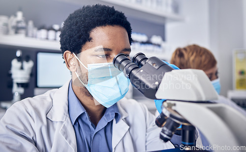 Image of Science, covid and black man in laboratory with microscope and face mask, motivation in future vaccine development. Healthcare, scientist or pharmacist with ideas and innovation in medical research.