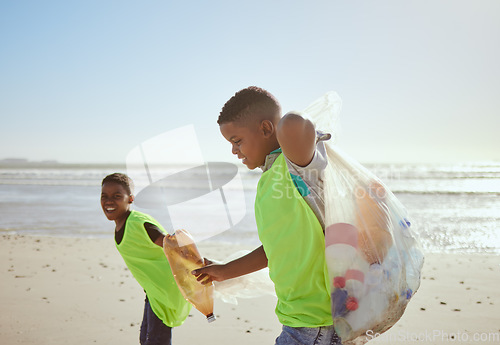 Image of Children, beach and pollution with friends cleaning plastic or litter from the sand by the sea or ocean. Nature, recycle and environment with volunteer kids picking up trash, waste or garbage