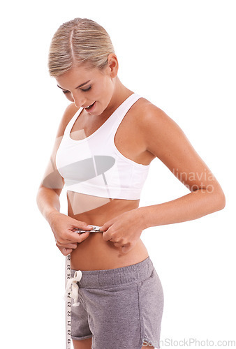 Image of Health, fitness and woman with tape measure for abdomen in studio isolated on a white background. Diet, wellness and slim female model measuring waist to track weightloss goals, progress or targets.