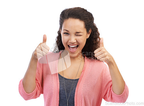 Image of Face portrait, thumbs up and wink of woman in studio isolated on a white background. Hands gesture, like emoji or happy female model with sign for success, support or approval, thank you or agreement