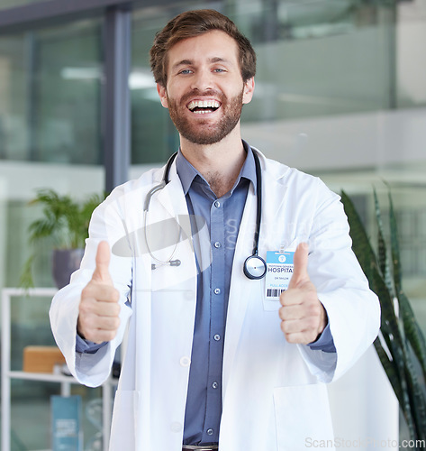 Image of Thumbs up, healthcare and portrait of doctor success, thank you for support and trust with goal, target and wellness motivation. UK medical worker with like, support or thanks hands sign in hospital