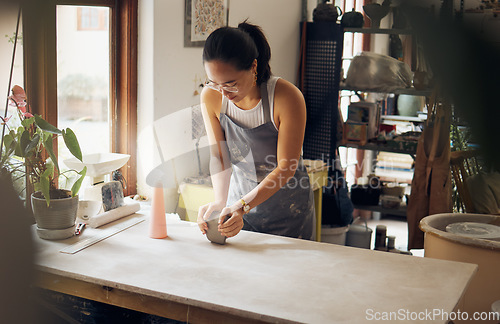 Image of Creative, small business and pottery girl working with clay for idea, inspiration and art process. Creativity, business owner and asian woman focused at artistic workspace in Tokyo, Japan