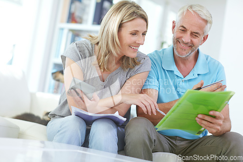 Image of Senior couple, home budget and finance with a calculator and bills for investment, savings or debt. Man and woman in happy marriage with paperwork for retirement, mortgage or to invest pension