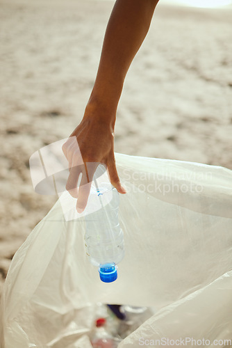 Image of Cleaning, plastic and hands of volunteer at beach for recycle, environment or earth day. Recycling, sustainability and climate change with charity person and trash bag for pollution and eco friendly