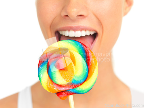 Image of Candy, lollipop and sweets with a woman in studio isolated on a white background eating a sweet snack. Food, bright or color with a young female holding and licking a giant lolly closeup alone