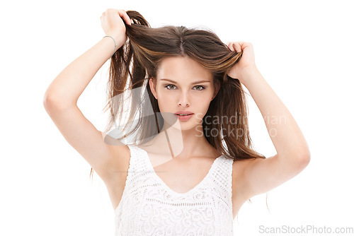 Image of Portrait, hair and beauty with a model woman in studio on a white background for keratin treatment at a salon. Face, haircare and natural aesthetic with a young female holding her straigh hair