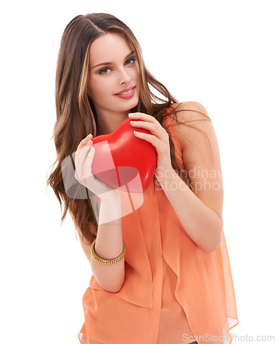 Image of Portrait, heart and love with a woman in studio on a white background holding an emoji, icon or shape. Red, romantic and valentines day with a young female holding a symbol or romance in her hands