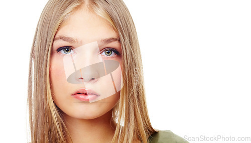 Image of Young, portrait and girl model in studio with mock up space doing serious, confident and natural pose. Beauty, headshot and face of beautiful female teenager posing while isolated by white background