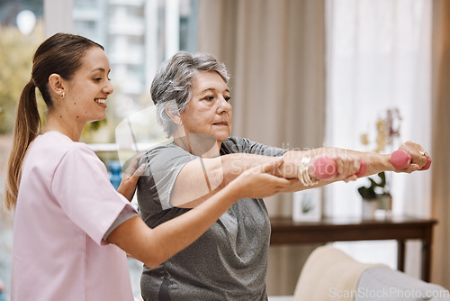 Image of Women, senior or physiotherapy help with dumbbell in wellness clinic, healthcare center or nursing home living room. Smile, happy or physiotherapist nurse and elderly patient in weight rehabilitation