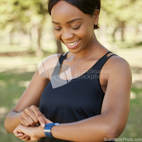 Image of Fitness, watch and runner with a sports black woman in the park for cardio exercise or endurance fitness. Health, app and training with a female athlete tracking her run or progress on a smartwatch