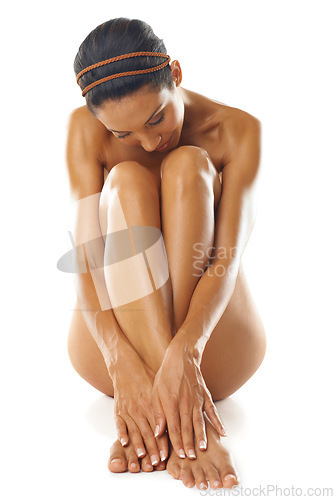 Image of Body, nude and woman on floor with skincare, natural beauty and dermatology on studio background. Female, lady and nudist on ground, wellness and grooming for luxury spa treatment and skin cosmetics
