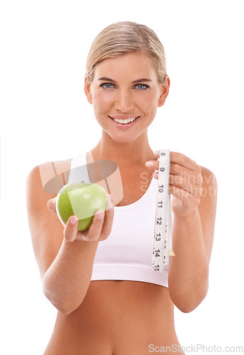 Image of Woman, studio portrait and apple with measure tape for wellness, diet or happiness by white background. Isolated model, fruit and goal to lose weight with vitamin c, natural nutrition or healthy food