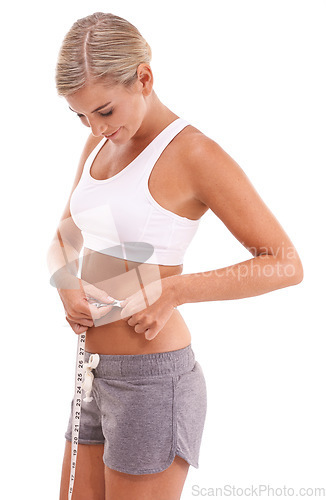Image of Fitness, health and woman with tape measure for abdomen in studio isolated on a white background. Diet, wellness and slim female model measuring waist to track weightloss goals, progress or targets.