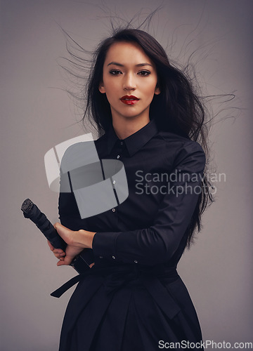 Image of Beauty portrait, sword and samurai woman art in ninja or warrior fashion to fight for power and fantasy. Asian female from Japan in black cosplay and makeup for action with metal weapon for art deco