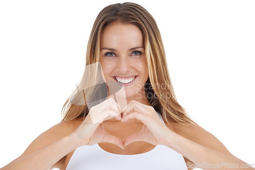 Image of Portrait, hand and heart by woman in studio happy, relax and smile against a white background. Face, love and emoji by girl showing shape with hands for care, peace and kindness on isolated space