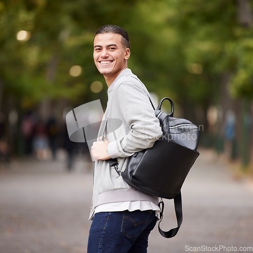 Image of Student portrait and university man travel commute in park with backpack and optimistic smile. Happy, youth and gen z college learner smiling while commuting in New York, USA with bokeh lights