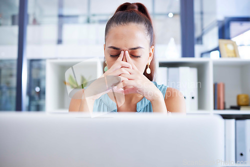 Image of Business woman with mental health, stress and headache with anxiety at office, fatigue or corporate burnout. Pain, tired with laptop glitch and frustrated professional and depressed female at work