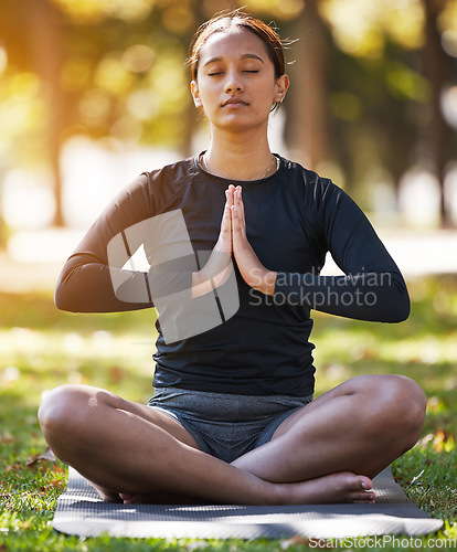 Image of Relax woman, namaste and meditation at park, wellness or freedom of chakra energy, zen fitness or peace. Young girl, yoga exercise and lotus praying in nature with eyes closed, mental health and calm