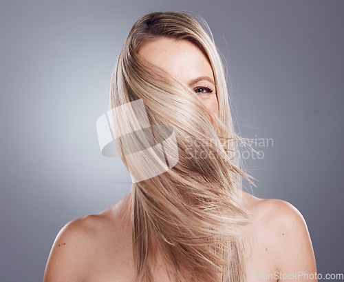 Image of Woman portrait, blonde or windy hairstyle on studio background for keratin treatment, healthcare wellness or self care grooming. Skincare beauty model, hair care or dye color for argan salon product