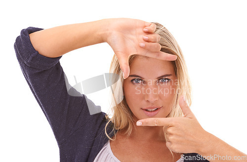 Image of Portrait, hands and finger frame with a woman in studio on a white background framing her face. Beauty, fingers and photography with an attractive young female posing for skincare or wellness