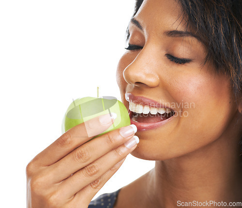 Image of Woman, studio and apple with smile, nutrition and hungry for healthy, organic snack and eating by white background. Black woman, happy and natural green fruit for diet, energy or wellness by backdrop