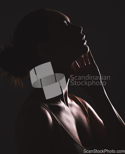 Image of Woman beauty silhouette, face and dark, sexy with cosmetics and seductive fantasy with mysterious aesthetic. Female profile with skin, sexy woman facial and shadow against black studio background.