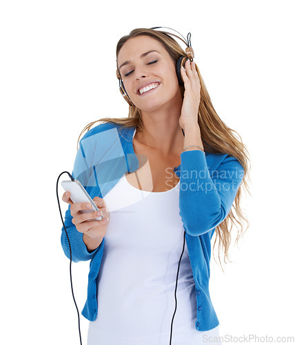 Image of Woman, studio and music headphones with smartphone, smile and relax by white background for happiness. Model, phone and streaming audio on internet app, website or radio while isolated for peace