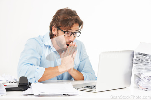 Image of Laptop, paperwork and shocked businessman working on a project with a deadline in a studio. Shock, surprise and professional male employee with a computer and corporate documents by white background.