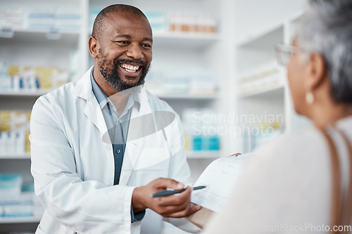 Image of Pharmacy, medicine and pharmacist in discussion with a patient explaining her prescription. Healthcare, medical and African male chemist speaking to a woman at a pharmaceutical clinic or drug store.