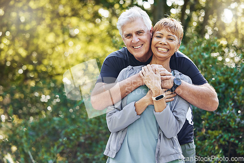 Image of Nature, love and man hugging his wife with care, happiness and affection while on an outdoor walk. Happy, romance and portrait of a senior couple in retirement embracing in the forest, woods or park.