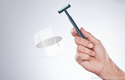 Image of Grooming, shaving and hand with a razor for body hair, hygiene and clean shave on a studio background with mockup. Cleaning, equipment and model with a product for trimming hairs for wellness