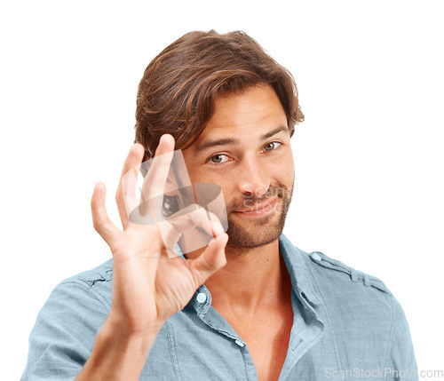 Image of Man, face and OK hand sign with portrait, agreement or good review, feedback and emoji against studio background. Yes gesture, success and vote with approval and male voice positive opinion